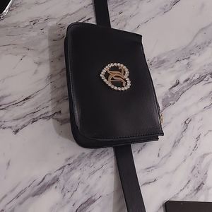 Juicy couture multi belt bag with gold zipper at the top.